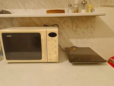 a microwave sitting on a counter next to a laptop at Charles bridge, Old town3 Min walk Private Room D in Prague