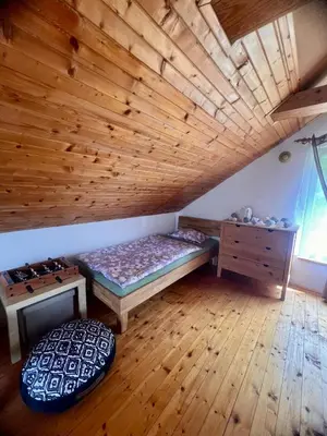 a room with a bed and a wooden ceiling at Chata Roda s vnitřní saunou in Rabyně
