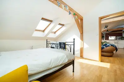 a bedroom with a bed and skylights at Bright and airy apartment in unique suburb in Prague