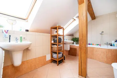 a bathroom with two sinks and a bath tub at Bright and airy apartment in unique suburb in Prague