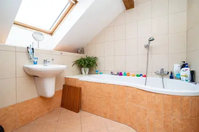 a bathroom with a bath tub and a sink at Bright and airy apartment in unique suburb in Prague