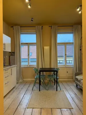 a kitchen with a table and chairs in a room at Small studio in hipster neighborhood in Prague