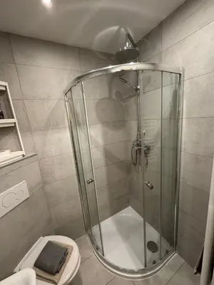 a shower stall in a bathroom with a toilet at Small studio in hipster neighborhood in Prague