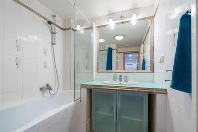 a bathroom with a sink and a shower and a mirror at Duplex City-Centre Apartment with a Sunny Terrace in Prague