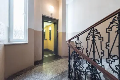 a hallway with a yellow door in a building at Large Duplex Apartment with a Sunny Terrace in Prague