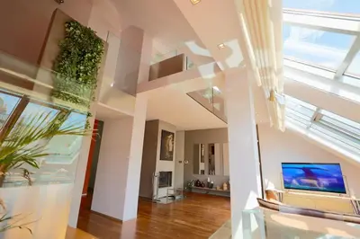 a living room with a ceiling with skylights at Luxury Prague Penthouse with Heated Floors, Castle Views & Rooftop Terrace in Prague