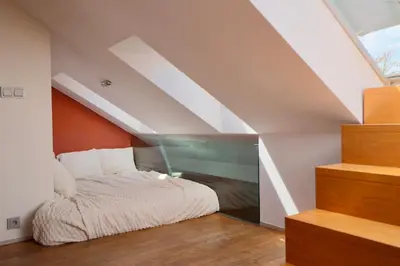 a bedroom with a bed in a attic at Luxury Prague Penthouse with Heated Floors, Castle Views & Rooftop Terrace in Prague