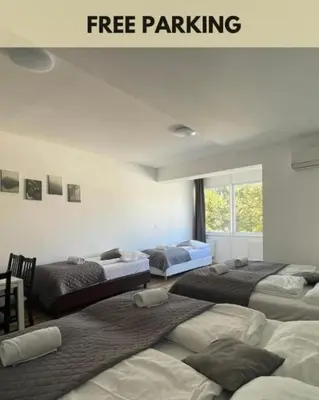 three beds in a room with free parking at MIRA apartments in Prague