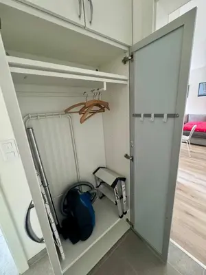 a closet with a door open and a bag at Byt u letiště v Praze in Tuchoměřice