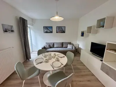 a living room with a table and chairs and a couch at Byt u letiště v Praze in Tuchoměřice