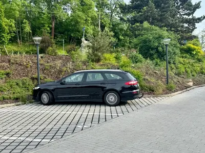 a black car parked on the side of a road at Byt u letiště v Praze in Tuchoměřice