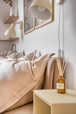 a bedroom with a bed and a table with a lamp at Sunset & Bloom Attic - Near parks & cafés in Prague