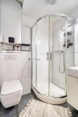 a bathroom with a shower and a toilet and a sink at Sunset & Bloom Attic - Near parks & cafés in Prague