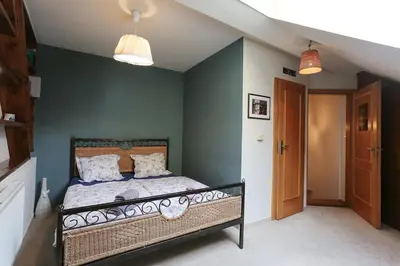 a bedroom with a bed and a blue wall at Central two floor flat by Charles Bridge in Prague