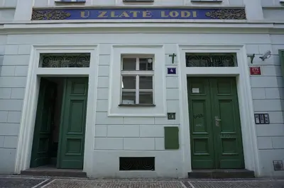 two green doors on the side of a building at Central two floor flat by Charles Bridge in Prague