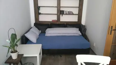 a small bedroom with a blue bed in a room at Central two floor flat by Charles Bridge in Prague