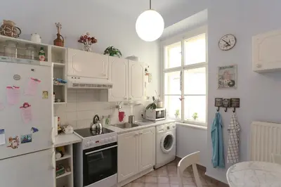a kitchen with white cabinets and a dishwasher at Central two floor flat by Charles Bridge in Prague