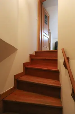 a stairway with wooden steps with a door at Central two floor flat by Charles Bridge in Prague