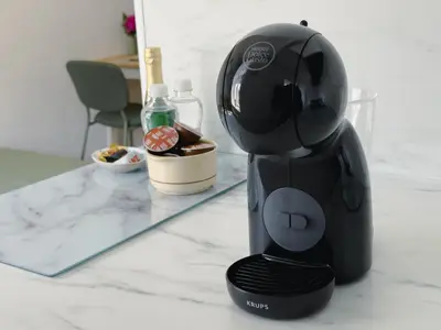 a black coffee maker on a counter next to a mirror at Cheerful apartment in the heart of Prague in Prague