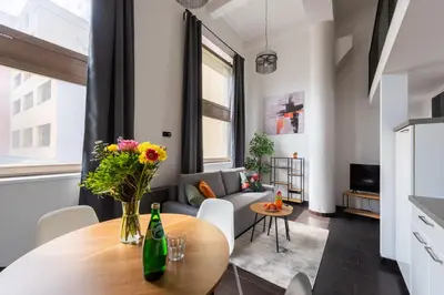 a living room with a table and a couch at Cozy apartments near Křižikova metro in Prague