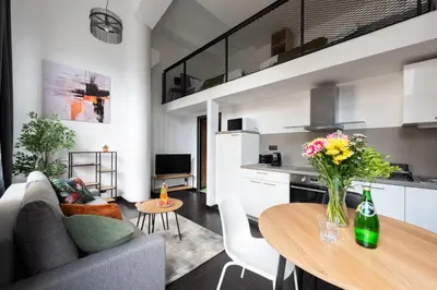 a living room with a couch and a table with flowers at Cozy apartments near Křižikova metro in Prague