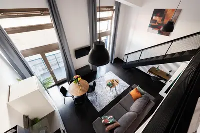 a living room with a couch and a table at Cozy apartments near Křižikova metro in Prague