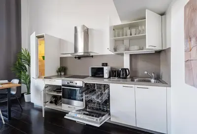 a small apartment with two beds and a table in a room at Cozy apartments near Křižikova metro in Prague