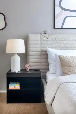 a bedroom with a bed and a nightstand with a lamp at Modern apartment near Old Town in Prague