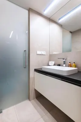 a bathroom with a sink and a mirror at Modern apartment near Old Town in Prague