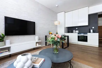 a living room with a vase of flowers on a table at Modern apartment near Old Town in Prague