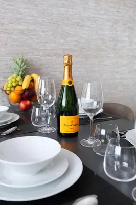 a bottle of wine sitting on a table with glasses at Modern apartment near Old Town in Prague