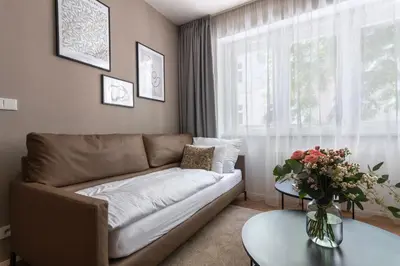 a living room with a couch and a window at Modern apartment near Old Town in Prague