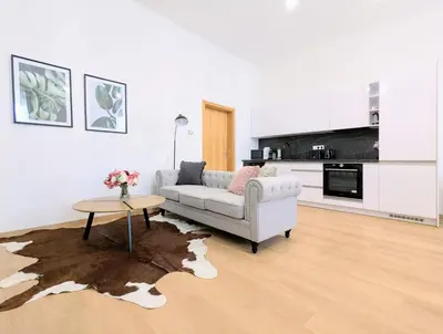 a living room with a couch and a table at New Town 2 BDR, free coffee in Prague