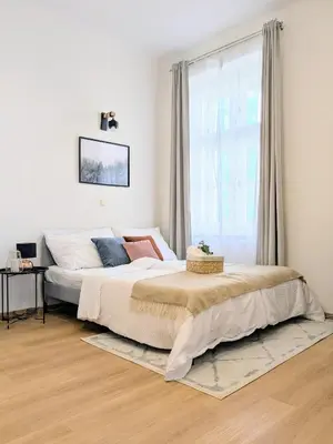 a bedroom with a large bed and a window at New Town 2 BDR, free coffee in Prague