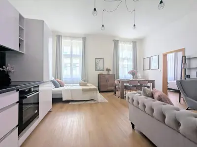 a living room with a couch and a table at New Town 2 BDR, free coffee in Prague