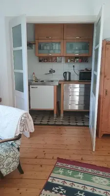 a kitchen with a counter with a sink and a microwave at Green Point - 25 min to the center by tram in Prague