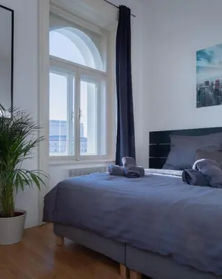 a bedroom with a large bed with a window at Central Studio by Museum and Old Town in Prague
