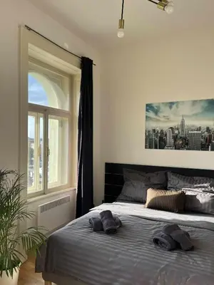 a bedroom with a bed with two towels on it at Central Studio by Museum and Old Town in Prague