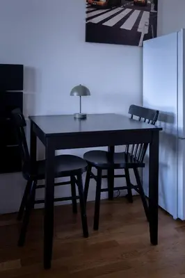 a black table with two chairs and a lamp on it at Central Studio by Museum and Old Town in Prague