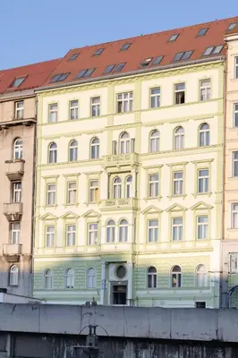 a yellow building with a red roof at Central Studio by Museum and Old Town in Prague