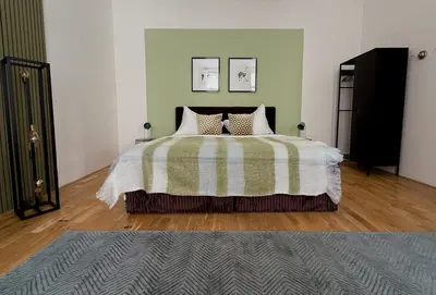 a bedroom with a bed with a green and white blanket at No2 Style & Design XXL City Centre Apartment in Prague