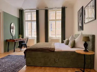 a bedroom with a large bed and a desk at No2 Style & Design XXL City Centre Apartment in Prague