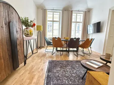 a living room with a table and chairs at No2 Style & Design XXL City Centre Apartment in Prague
