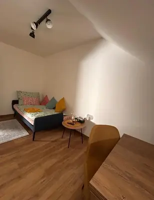 a living room with a couch and a table at Apartment Drahuska in Prague