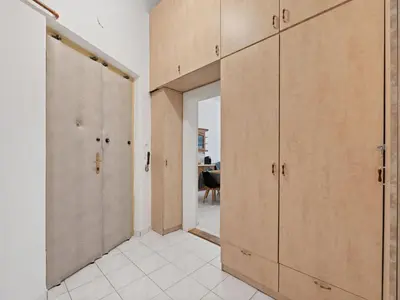 a hallway with wooden doors and a room with a table at Apartment Old Town home-7 by Interhome in Prague