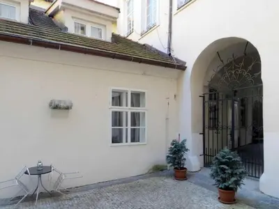 a white building with a gate and two potted plants at Apartment Old Town home-7 by Interhome in Prague