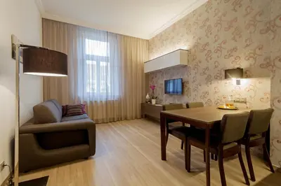 two pictures of a bedroom with a bed and a bathtub at VINOHRADSKY DUM Residence in Prague