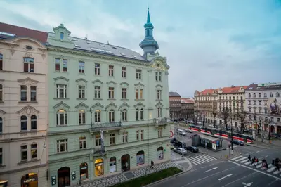 a large building on a street in a city at VINOHRADSKY DUM Residence in Prague