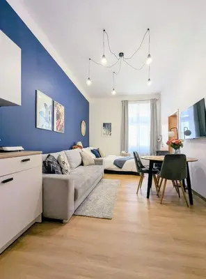 a living room with a couch and a table at New Town Studio, free coffee in Prague