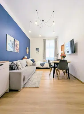 a living room with a couch and a table at New Town Studio, free coffee in Prague